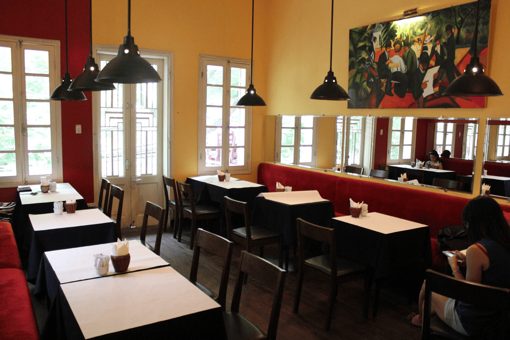 The bakery offers a cozy atmosphere with warm yellow and red tones (Source: Saint-Honoré Hanoi)